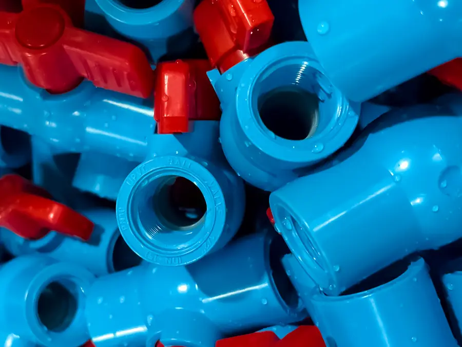 JARO compact ball valve OEM closeup with red handle and blue valve body for industrial piping systems